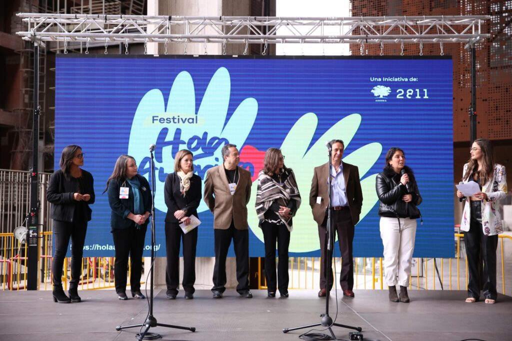 Participantes del festival Hola América comentan arriba del escenario